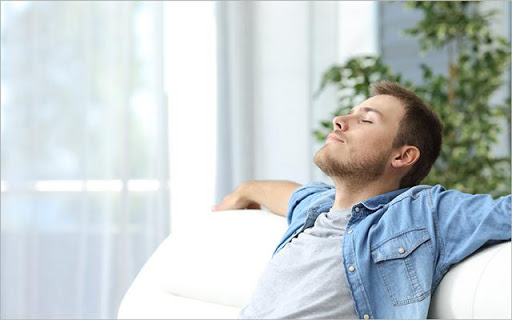 Man in a denim jacket relaxing on the couch