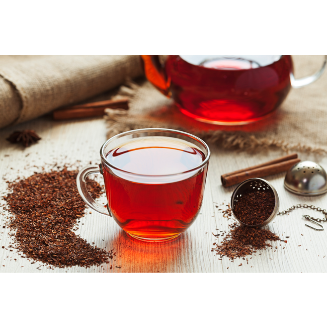 Red tea leaves and a cup of red tea